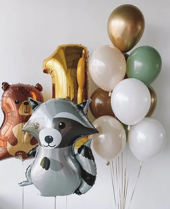 Gold number one balloon with woodland animal figures and green and ivory balloons
